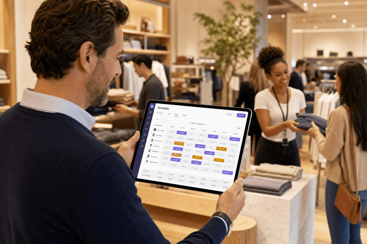Retail store manager reviewing crew schedules on a tablet